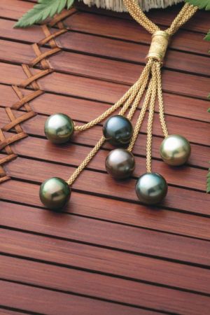 18Kt yellow gold necklace holding six multi-hued Tahitian Pearls immerses the wearer in its beauty